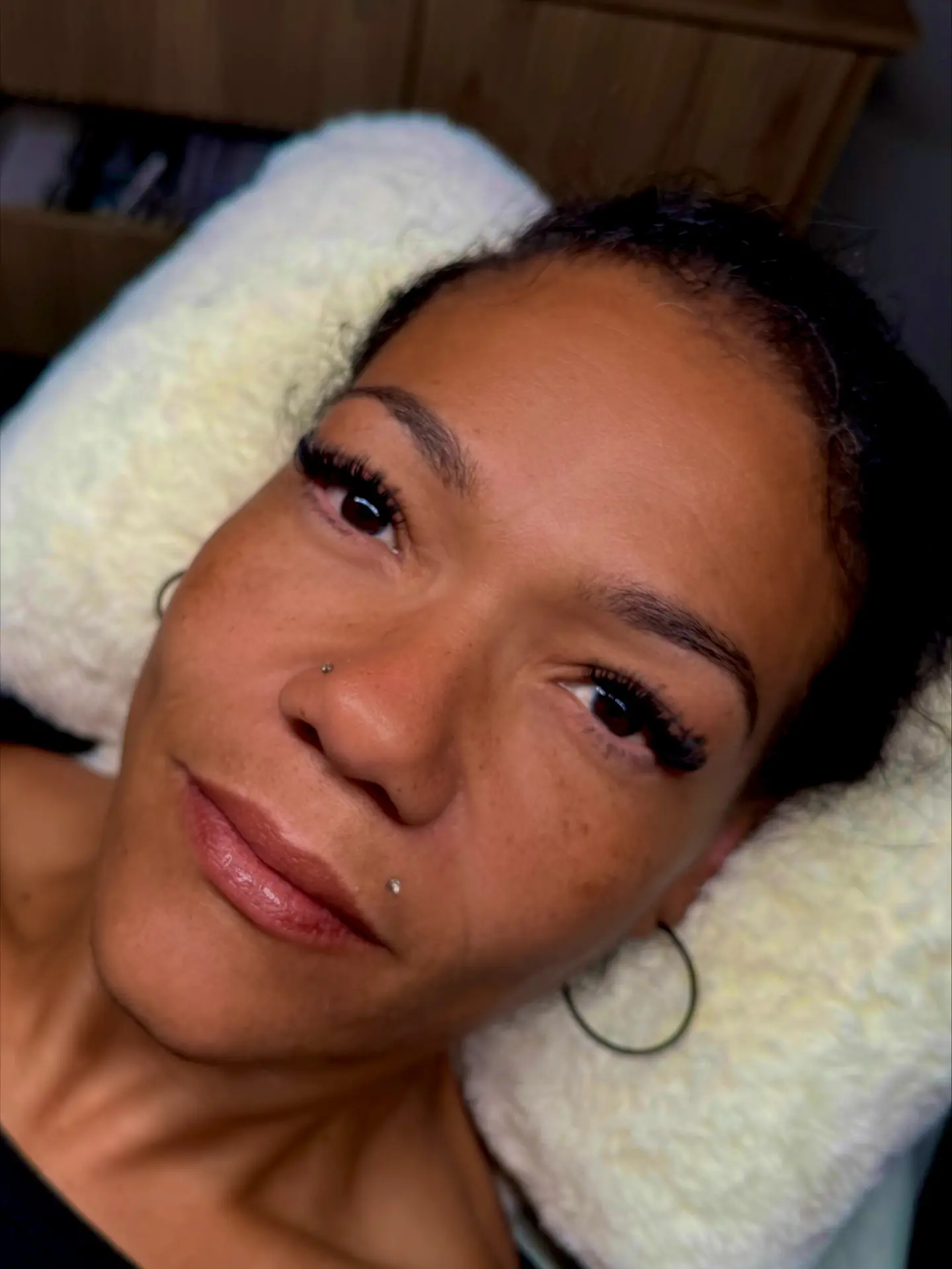 Freshly applied lash extensions blending with natural lashes
