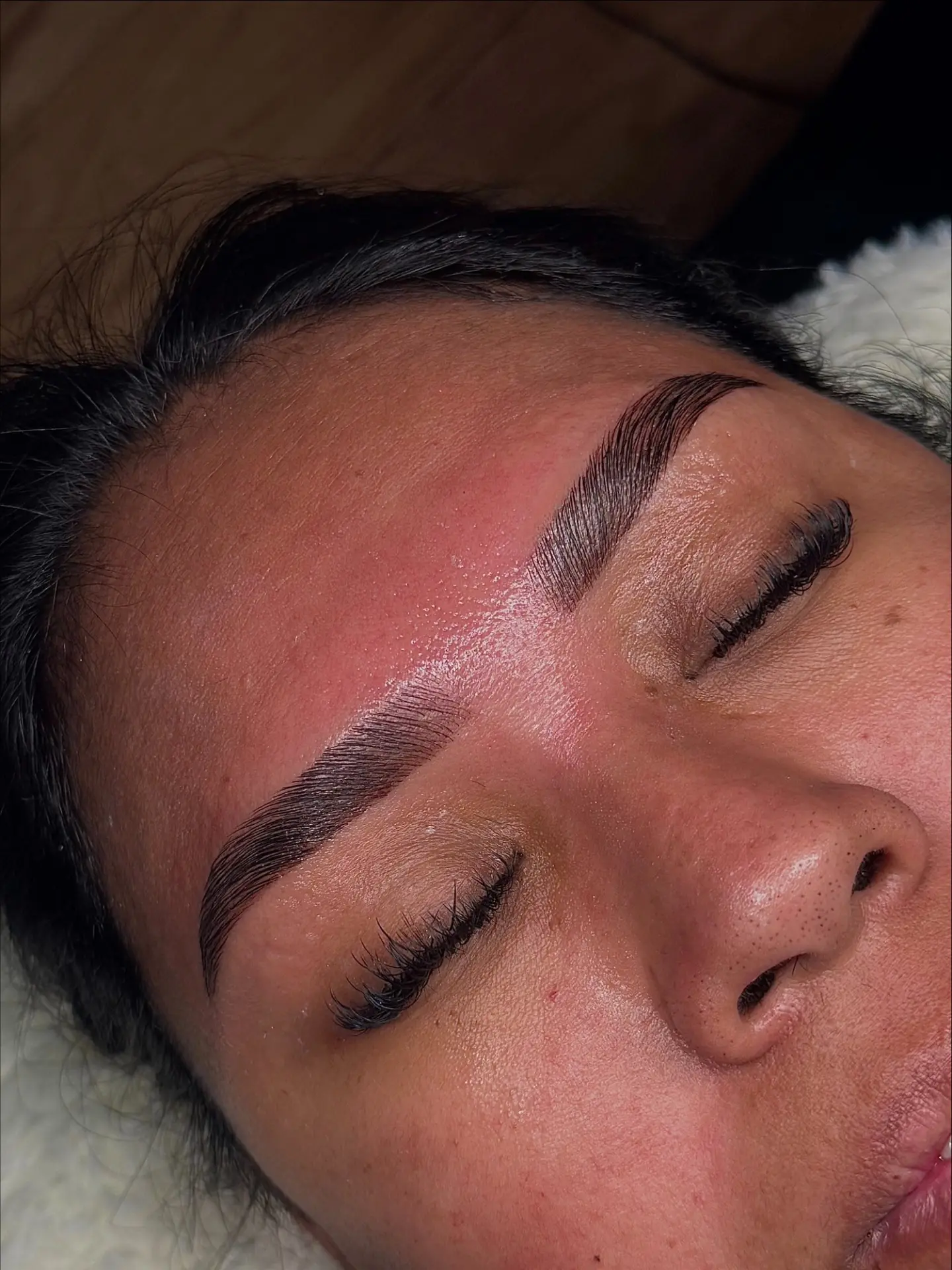 Freshly laminated and tinted brows with a sleek, brushed-up shape